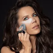 A polished headshot of Tati Westbrook featuring her signature soft-glam makeup—neutral eyeshadow, defined brows, and a nude lip.